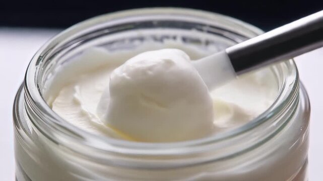 Macro of whipped moisturizer on spatula transforming into cloud puff. Realistic transformative sensory innovative formulation