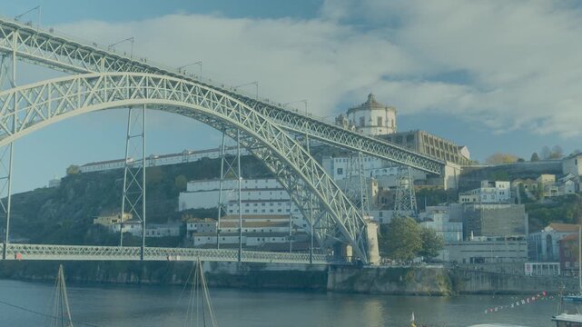 Panoramic view of the Dom Luis I bridge spanning across the Douro. Dom Luis I Bridge with Serra do Pilar visible in the background in Porto.