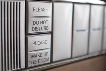 Hotel door buttons for service requests on a panel