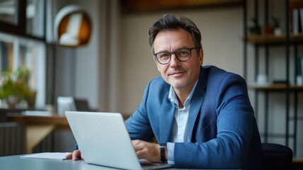Portrait of a confident businessman laptop executive glasses.