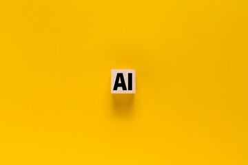 AI symbol or artificial intelligence on wooden blocks. isolated on yellow background
