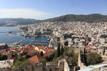 panoramic overhead view of the port city of Kavala, Greece. Aerial shot of Kavala showing, the shoreline, the docs the clay rooftops and the mountain chains beyond