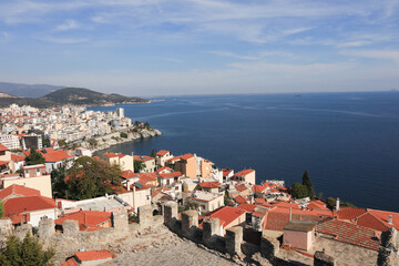 Aerial view of the port city of Kavala, Greece. Overhead shot of Kavala featuring clay rooftops and the shoreline on a sunny day