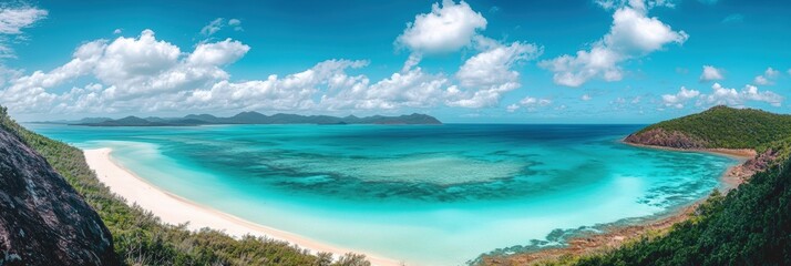 A stunning panoramic view of a tropical beach with turquoise waters, white sand, and lush greenery under a bright blue sky dotted with clouds.