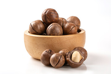 Pile of premium macadamia nuts in shells and cracked kernels in a rustic wooden bowl. Isolated on white background, ideal for healthy snack branding and organic food products.