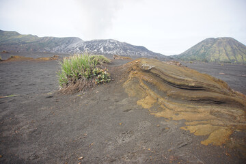 Rocky volcanic terrain and black sand sea at Mount Bromo National Park, Indonesia