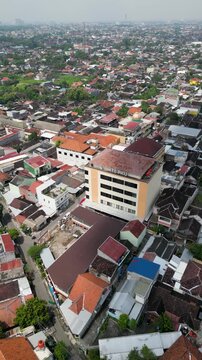 Aerial view of the ITS PKU Solo campus building with its modern architecture standing amid urban surroundings, blending educational facilities with the city landscape and greenery.