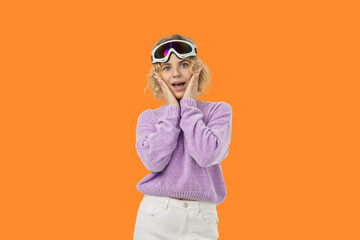 Blonde woman in ski goggles and a purple sweater