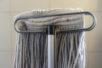 Close up of cotton mop head with aluminum handle