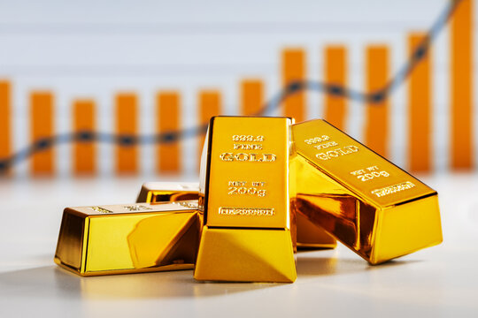 Close-up of gold bars and an upward trend. Rising gold price concept.
