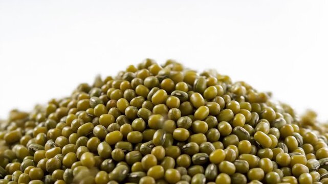 Mung Bean Pile with Falling Beans - A close-up shot shows a large pile of mung beans with more beans falling onto the pile from above.