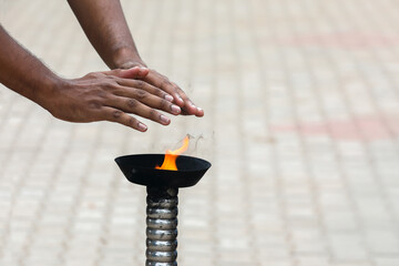 person Touching and bowing over a traditional burning camphor