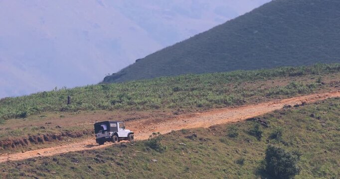 Off road sport utility vehicle struggling to climb on the scenic mountain road in Coorg district , Karnataka, India