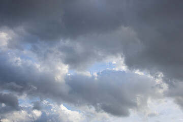 Fototapeta premium A wide shot of a sky filled with various shades of grey and dark clouds, suggesting an impending storm