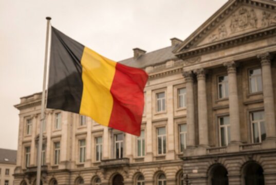 Belgium flag waving in front of a majestic neoclassical building. National symbol and government architecture for official use. European pride.