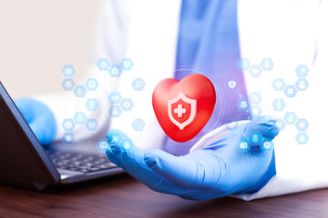 A doctor reviews health insurance plans on a laptop. Concept of health coverage and digital protection. The doctor displays a heart icon, a medical shield. Medical icons. Digital medicine