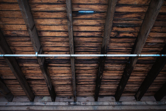 Looking up at exposed wooden floorboards in an old warehouse - horizontal