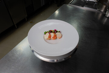 An elegant dish of beautifully arranged food on a pristine white plate