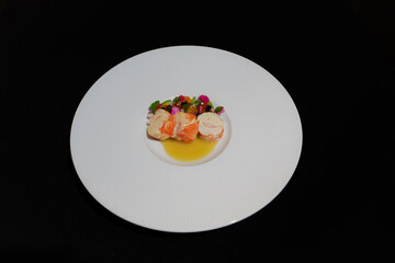 Elegant cuisine presentation on a white plate with dark background