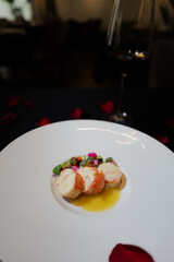 Elegant culinary presentation of delectable gourmet food. The dish is presented on a pristine white plate and features elements that evoke fine dining
