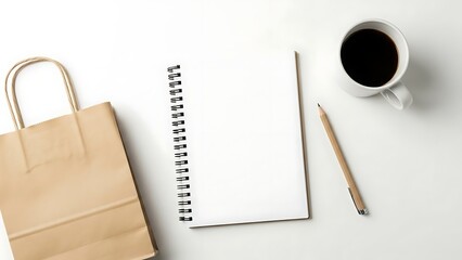 Flat lay of a brown paper shopping bag, open notebook, pencil, and coffee cup on a white background.