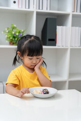 child girl presses hand to cheek after eat sweet, suffers from pain in tooth. Teeth decay, dental problems, child emotions and facial expression, oral health care, fluorine coating, reduce sweets