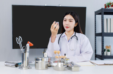 Portrait confident asian female doctor with stethoscope sitting at desk professional office medical clinic hospital holding look at medicine glass, system physician expertise healthcare consultation.