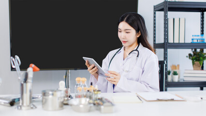 Portrait confident asian female doctor working at desk with laptop computer professional office medical clinic hospital stethoscope documents system physician expertise in healthcare consultation.