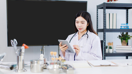 Portrait confident asian female doctor working at desk with laptop computer professional office medical clinic hospital stethoscope documents system physician expertise in healthcare consultation.