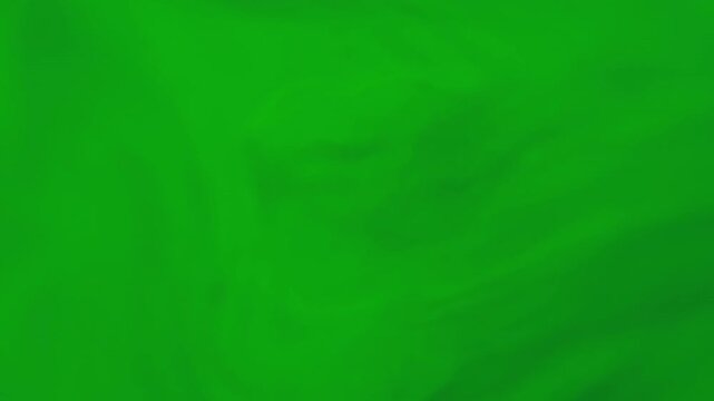 Blend flow. Color water. Defocused green ink fluid liquid shiny stream emulsion spreading on abstract wet dark black art background.