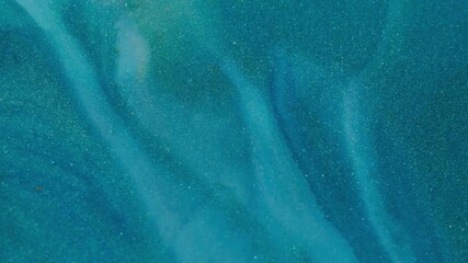 Floating emulsion. Shiny fluid. Defocused blue cyan color ink glitter chemical liquid substance spreading on abstract creative background.