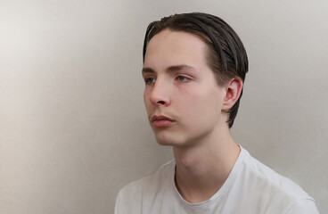 Fototapeta premium Portrait of a young man with a beautiful hairstyle.
