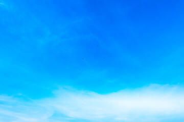 Obraz premium A bright, clear blue sky meets a glowing white horizon, suggesting a serene, open, and with sunlight of beautiful cloudy sky. landscape or abstract background