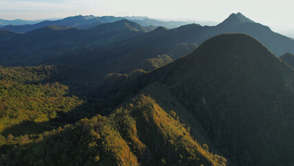 Fototapeta premium Aerial view from drone of the mountains and forest before sunset in Chiangmai, Thailand