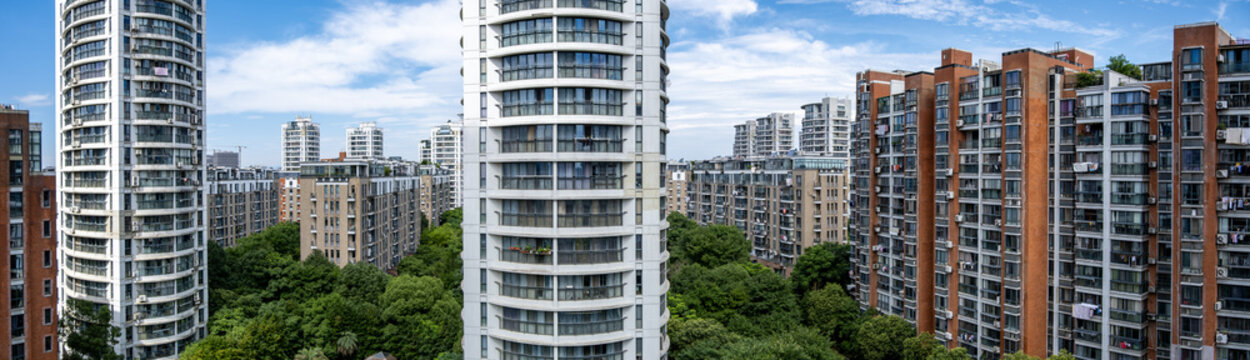 Panorama of modern high-rise residential apartment towers forming a compact city housing cluster in China. High-density urban living showing contemporary housing and vertical city growth.