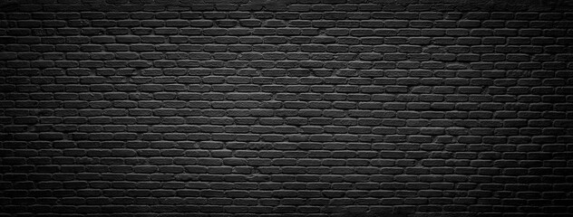old blackened brick wall background, dark texture of rough brickwork