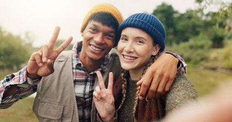 Peace sign, selfie and portrait of couple in nature for adventure, social media post and hiking...