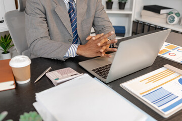 Businessman working at his desk in professional office environment, focusing on decision making, financial planning, and daily responsibilities that reflect modern corporate work and management tasks.
