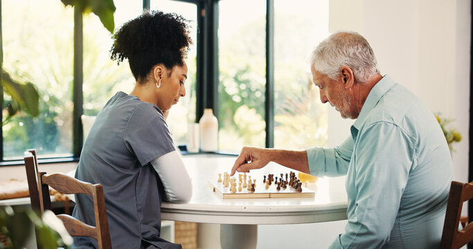 Senior man, nurse or playing chess with board game for interaction or activity in retirement home. Caregiver, volunteer or assisted living with elderly patient for nursing tactics or problem solving