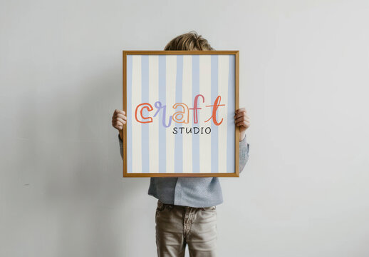 Child Holding Framed Craft Sign Mockup PSD