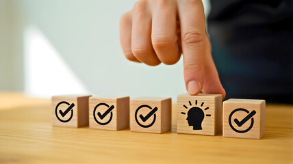 Hand placing a lightbulb idea block among completed checkmark cubes, symbolizing the strategic integration of creative solutions and innovative concepts for achieving business goals and progress