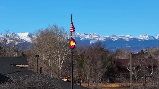 Colorado USA Flags windy Boulder Lafayette Erie Longs Peak Colorado aerial drone December winter morning Front Range Flat Irons Mountains foothills homes buildings sunny vast blue sky Boulder County