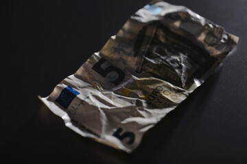 Wrinkled five euro banknote  symbolizing poverty, last money, crisis, or financial hardship