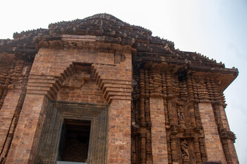 Fototapeta premium Intricately carved sandstone walls of Konark Sun Temple rise majestically, showcasing Kalinga architecture, mythological sculptures, and ancient Odisha craftsmanship heritage. 