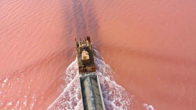 Burlinskoye Lake (Bursol), Altai Krai &mdash; Pink Salt Lake. A train‑like vehicle moves along the shore.