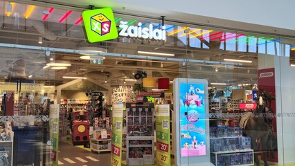 Obraz premium Vilnius Lithuania - 03.29.2025 Brightly lit toy store with colorful signage and wide selection of toys, including LEGO, plush animals, and action figures, creating a fun and welcoming atmosphere