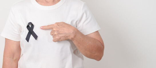 Elderly with Black ribbon for May Melanoma and skin cancer Awareness month, October Vaccine injury awareness month, Mourning Remembrance, March Sleep awareness week, Gang Prevention and Anti Violence