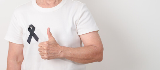 Elderly with Black ribbon for May Melanoma and skin cancer Awareness month, October Vaccine injury awareness month, Mourning Remembrance, March Sleep awareness week, Gang Prevention and Anti Violence