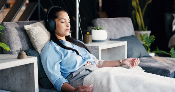 Relax, woman and drip therapy with headphones in lounge for immune health, music or saline solution. Calm, patient and sleeping with IV infusion for hydration, hormonal imbalance and audio playlist