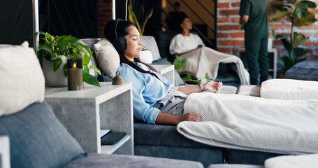 Headphones, woman and relax at drip therapy in lounge for immune health, saline solution or music....